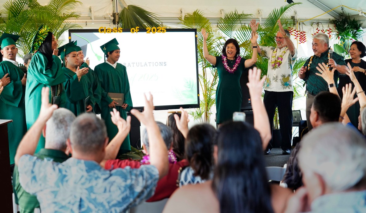 Hawaiʻi School for the Deaf and Blind 2025 graduates Genesis Mose, from left in back, Kaiyah Ann Pacleb, Odreigh Maskell, Thanicia Gideon, second left in front, Zion Sale, Tessie Radl and Mikaiah Ventura thank their family, friends, teachers and school staff as they applaud their achievements Wednesday, May 28, 2025, in Honolulu. Joining them on the stage are Hawaiʻi Department of Education Complex Area Superintendent Rochelle Mahoe, HSDB Principal Angel Ramos and Superintendent Keith Hiyashi. (Kevin Fujii/Civil Beat/2025)