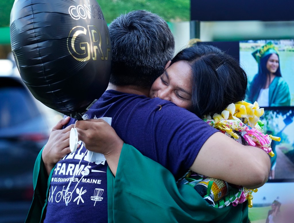 Hawaiʻi School for the Deaf and Blind teacher Brien Nakamoto hugs graduate Thanicia Gideon Wednesday, May 28, 2025, in Honolulu. (Kevin Fujii/Civil Beat/2025)