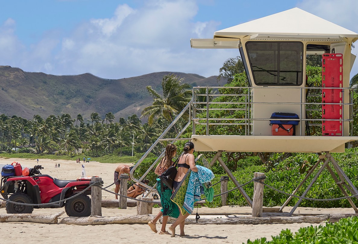 Kurt Lager, Honolulu City and County Ocean Safety Director is photographed at Kalama Beach Park in Kailua where typical safety signs warned of hazardous conditions that beach-goers seemed to ignore as they frolicked in the ocean.(David Croxford/Civil Beat/2025)
