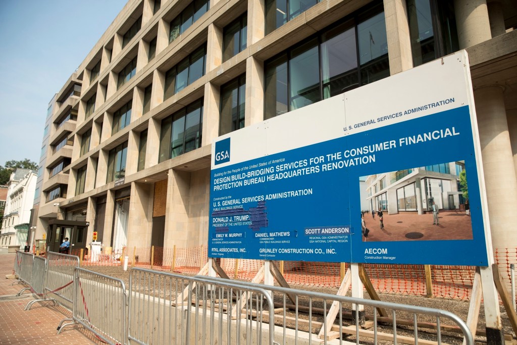 FILE - In this Aug. 27, 2018, file photo, a patched sign stands at the construction site for the Consumer Financial Protection Bureau's new headquarters in Washington. The Supreme Court is hearing a case on Dec. 9, 2020, that could make it easier for the president to fire the head of the agency that oversees government-controlled mortgage giants Fannie Mae and Freddie Mac. The case could also mean undoing an arrangement between the companies and the government that has sent $246 billion in their profits to the Treasury. That was compensation for the taxpayer bailout they received after the 2007 housing market crash. (AP Photo/Andrew Harnik, File)