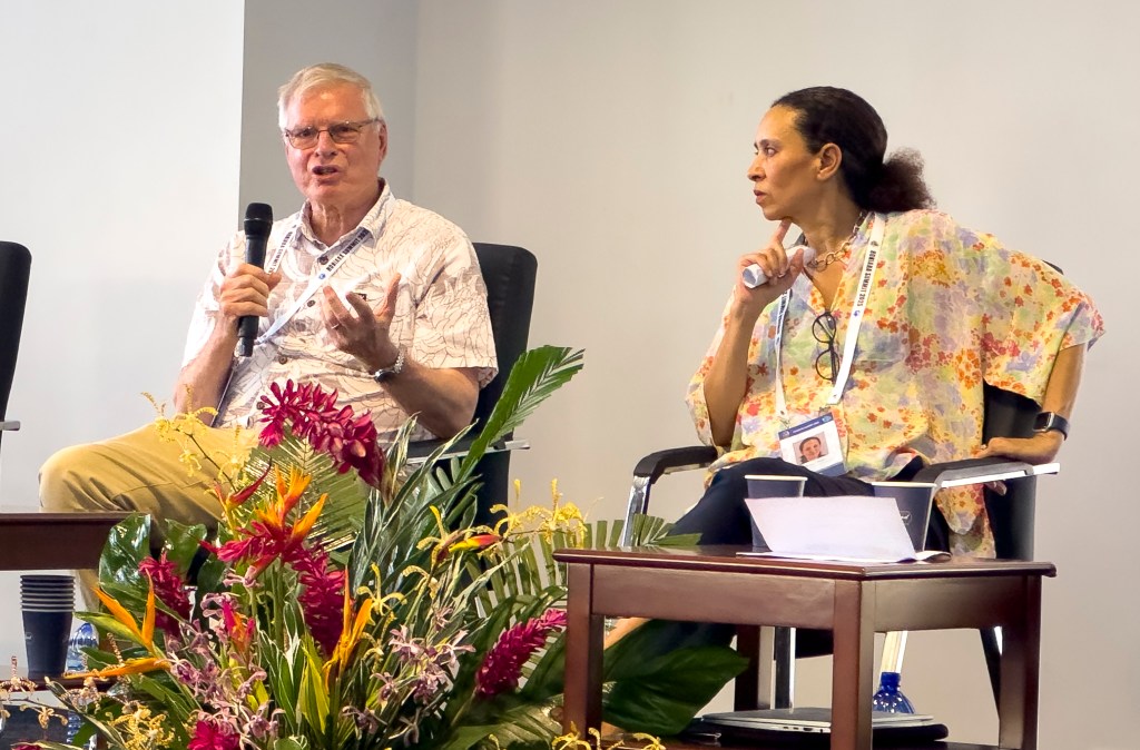 Johann Bell, left, and Tarub Bahri discuss the impacts of climate change on tuna stocks during a side event at the Honiara Summit in February. (Nathan Eagle/Civil Beat/2025)