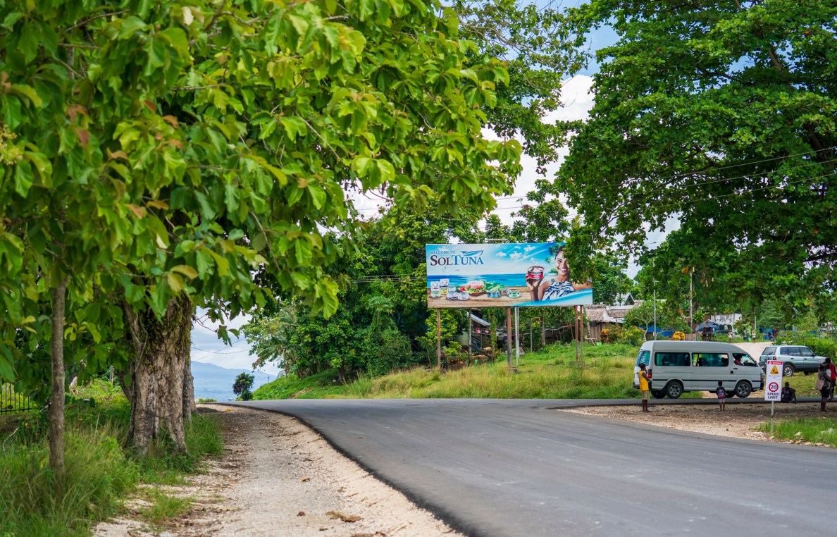 A sign advertises SolTuna canned tuna in Noro just up the road from the cannery. (Nathan Eagle/Civil Beat/2025)