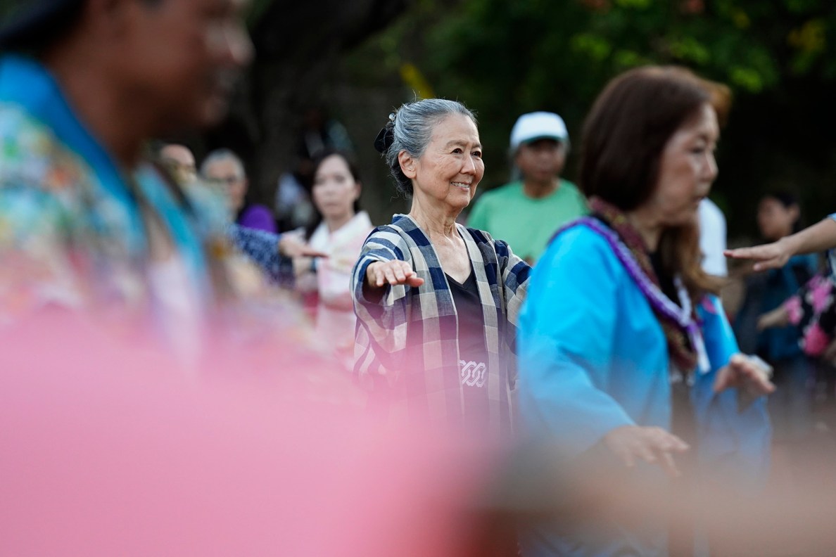 Lisa Nakata smiles during the first Bon Dance of the season Saturday, June 7, 2025, at Hawaii’s Plantation Village in Waipahu. “Dancing makes me so happy and I’m happy it’s back!” Nakata said. (Kevin Fujii/Civil Beat/2025)