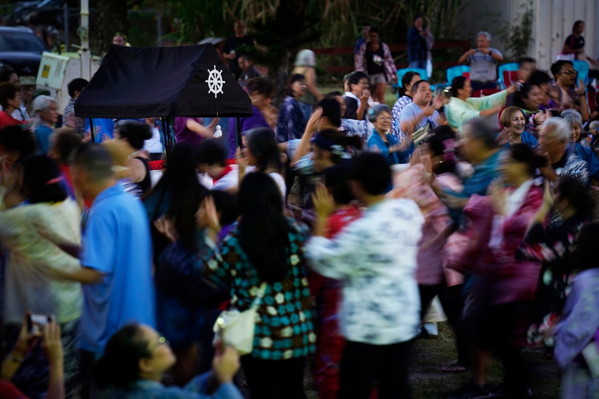The first Bon Dance of the season circles the yagura Saturday, June 7, 2025, at Hawaii’s Plantation Village in Waipahu. The summer Obon season is a Japanese Buddhist tradition to celebrate life and honor ancestors. (Kevin Fujii/Civil Beat/2025)