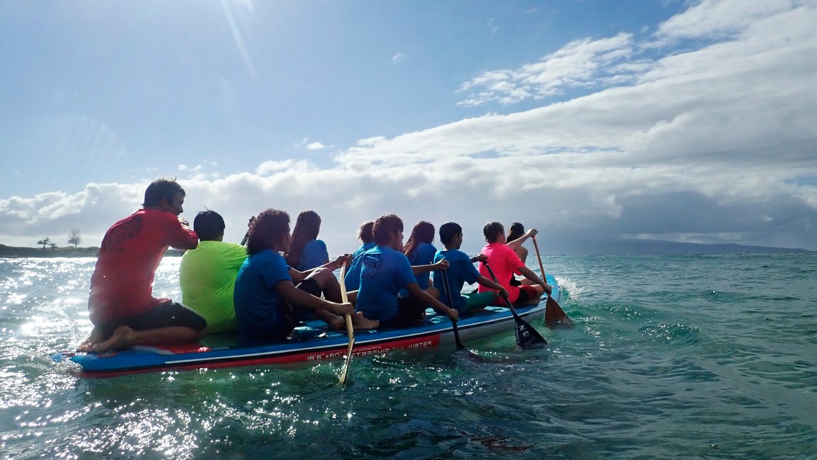Kahākūahi Ocean Academy’s Zane Kekoa Schweizer, left, steers the team-size inflatable SUP as Maui Hero Project youth paddle into the bay from D.T. Fleming Beach Tuesday, June 10, 2025, in Lahaina. (Kevin Fujii/Civil Beat/2025)