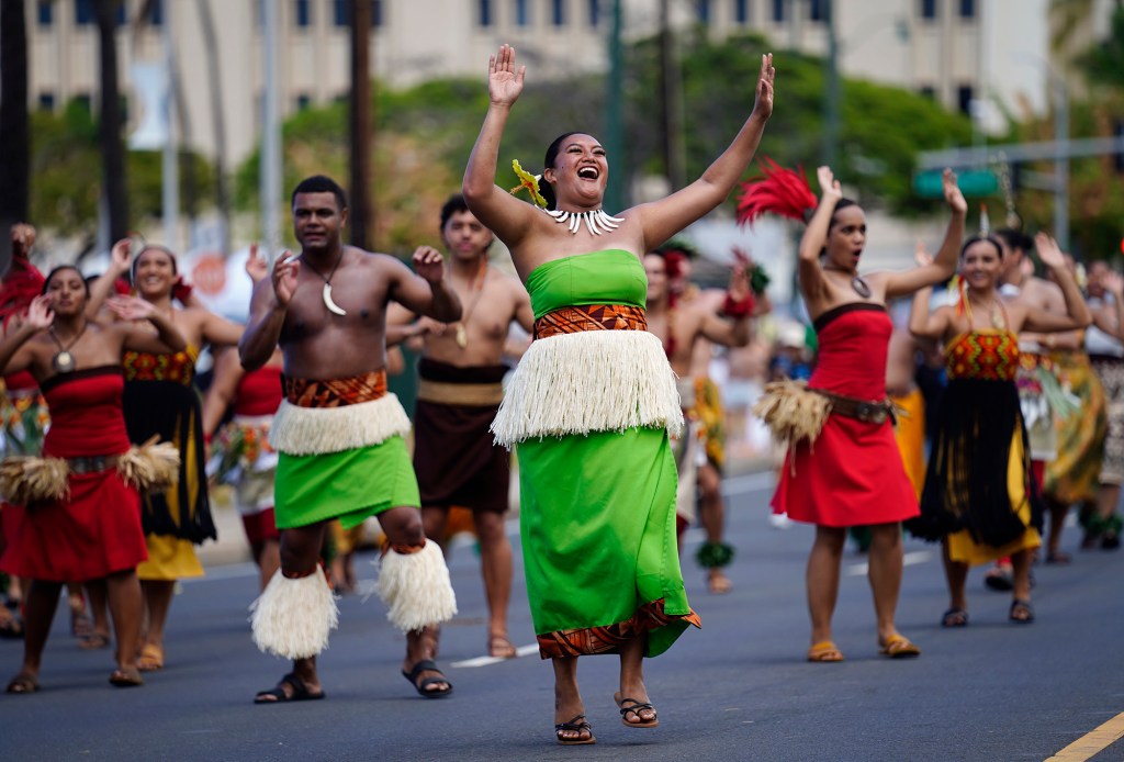 Polynesian Culture Center dancers entertain spectators during the 108th King Kamehameha Celebration Floral Parade Saturday, June 14, 2025, in Honolulu. In its 153 year, the King Kamehameha Day Celebrations honor Kamehameha I, the “Father of the Hawaiian Kingdom,” who united the Hawaiian Islands under one rule. His great-grandson King Kamehameha V established King Kamehameha Day in 1971. It was first observed on June 11, 1872. (Kevin Fujii/Civil Beat/2025)