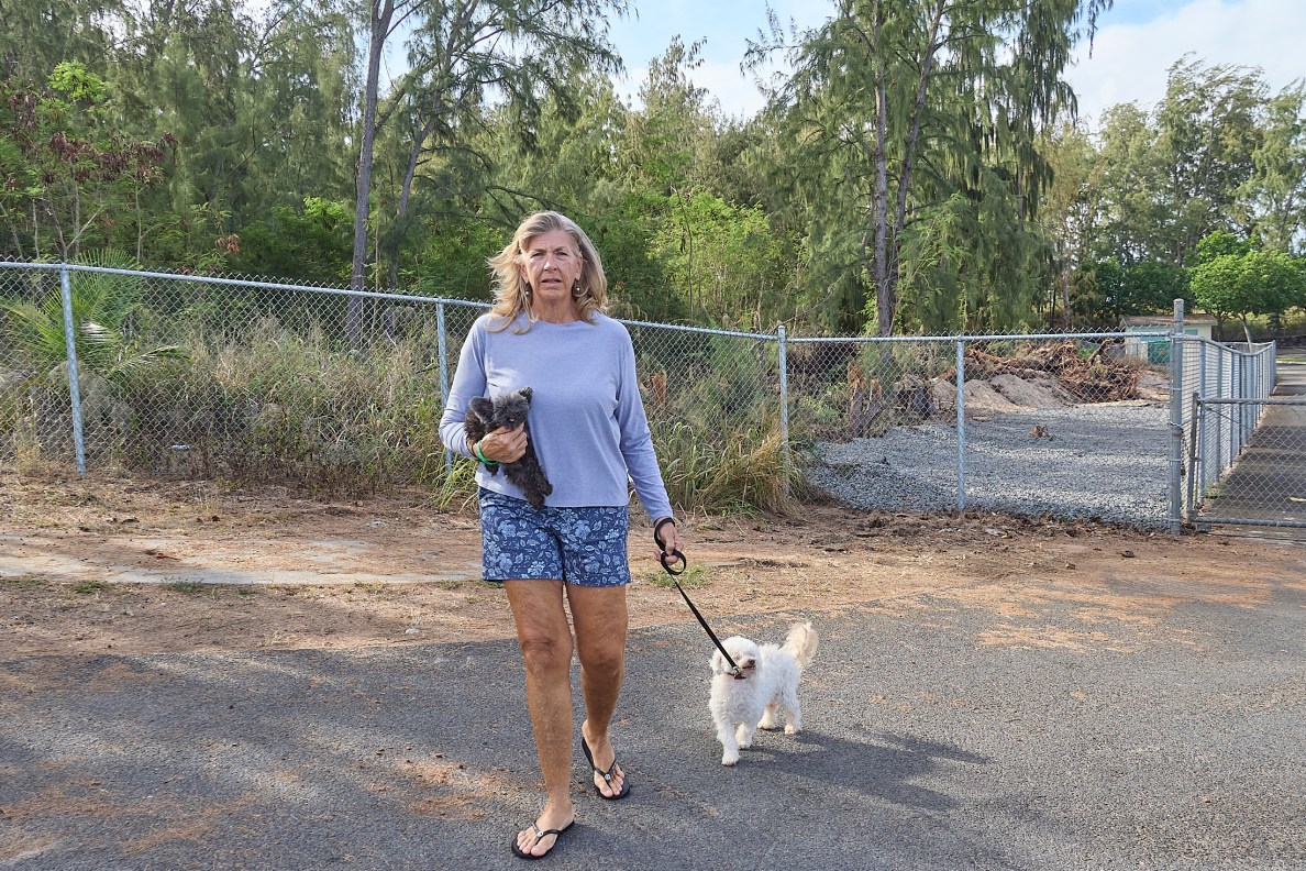 At Kahuku Hauoli Hale, Evelyn Lane is a resident. She walks her dogs regularly through the small development where there is only one way in and one way out of the Development that houses mostly seniors. Should there be any kind of disaster residents could suffer untold tragedy because of a lack of egress in emergency. (David Croxford/Civil Beat/2025)