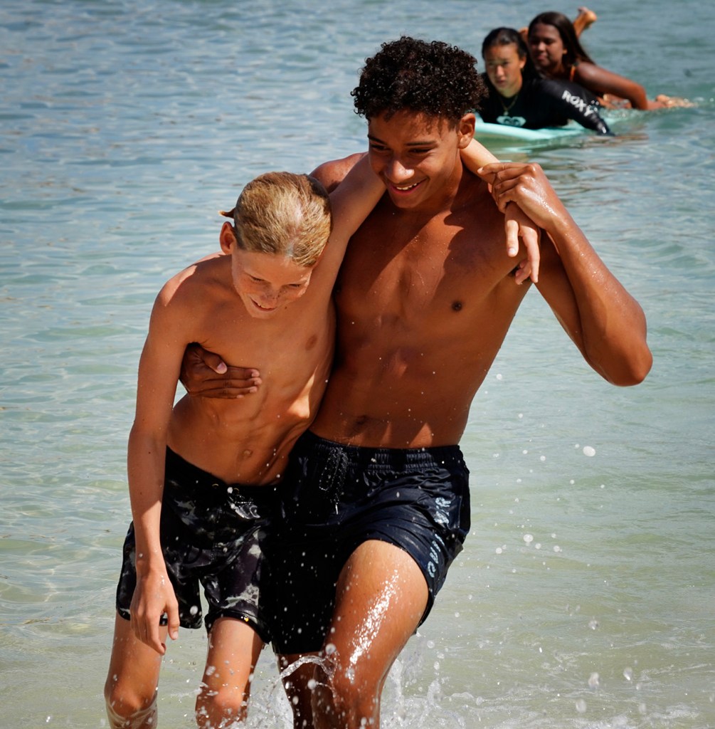 Honolulu Ocean Safety Department’s Junior Lifeguard Program participants Ezra Fritz, 10, gets rescued by Isaiah Smith, 16, at Ko’olina Thursday, June 26, 2025, in Kapolei. (Kevin Fujii/Civil Beat/2025)