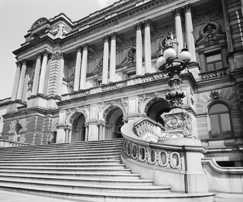 A view of the main entrance to the Library of Congress, in Washington, DC, April 6, 1950. Started in 1800 when congressmen decided they needed a library in which to look things up, today it has more than 8,500,000 books, 125,000 bound volumes of newspapers, 11,320,000 manuscripts, almost 2,000,000 maps and views, 80,000 reels of motion pictures, 2,000,000 volumes and pieces of music, 300,000 phonograph records. The library's two principal buildings, the old, ornate building (shown here) and the new annex, are the two largest buildings in the world devoted exclusively to library purposes. It takes 250 miles of shelves to hold its books.   (AP Photo/William J. Smith)