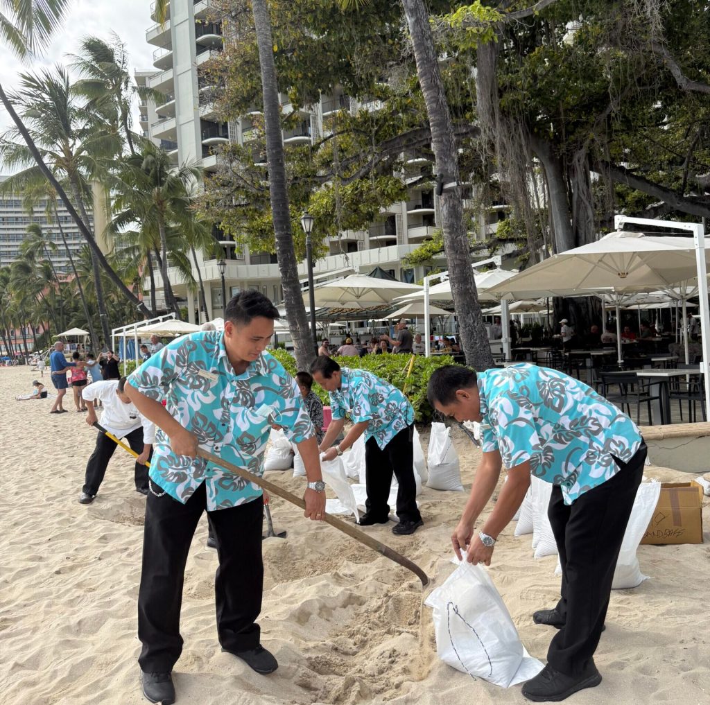 Hotel workers in Waikīkī fill sandbags on the otherwise empty beaches in preparation as the state faced a tsunami warning. (Provided Photo/2025)