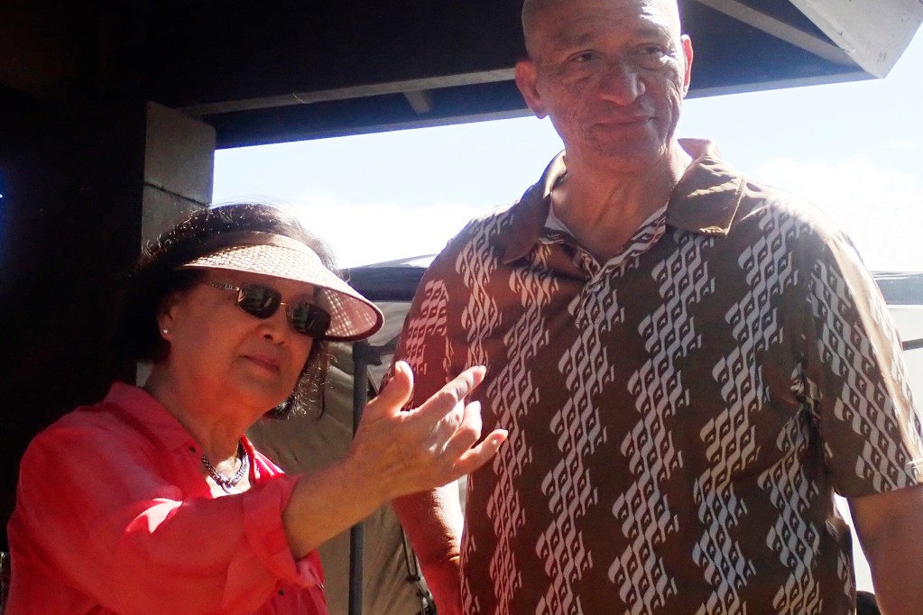 U.S. Sen. Mazie Hirono motions for someone to join a conversation with Maui Mayor Richard Bissen before the Kuhinia Maui memorial paddle-out from Hanaka‘ō‘ō Beach Park Friday, Aug. 8, 2025, in Lahaina. 102 people died in the Aug. 8, 2023, fire which destroyed the historic West Maui town and Upcountry. (Kevin Fujii/Civil Beat/2025)