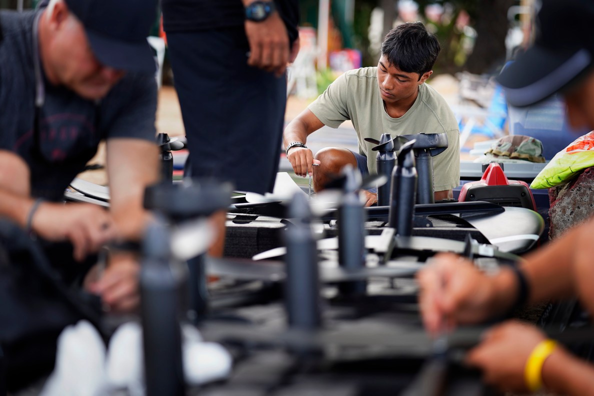 Kama Koa puts together an electric hydrofoil during the Hawaii Efoil Extravaganza 2025 Saturday, Aug. 9, 2025, at Ke‘ehi Lagoon in Honolulu. The first of its kind in Hawaiʻi, the day consisted of trying out e-foils and racing on a closed-circuit track for prizes. (Kevin Fujii/Civil Beat/2025)