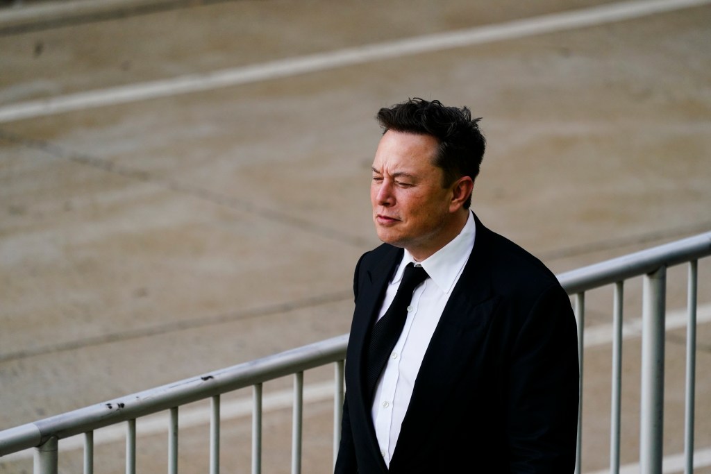 Elon Musk walks from the the justice center in Wilmington, Del., Monday, July 12, 2021. Musk took to a witness stand Monday to defend his company's 2016 acquisition of a troubled company called SolarCity against a shareholder lawsuit that claims he's to blame for a deal that was rife with conflicts of interest and never delivered the profits he had promised. (AP Photo/Matt Rourke)