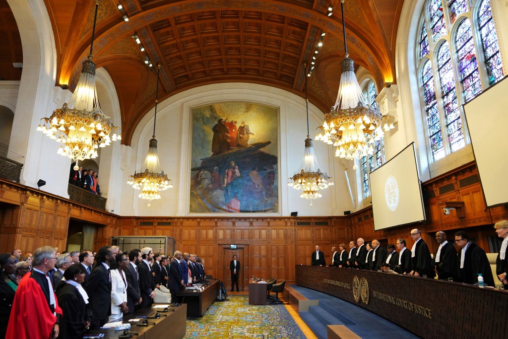 Judges, right, arrive to the International Court of Justice for an advisory opinion on what legal obligations nations have to address climate change and what consequences they may face if they don't, Wednesday, July 23, 2025, in The Hague, Netherlands. (AP Photo/Peter Dejong)