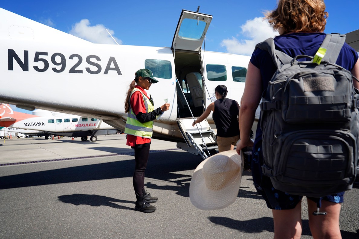 A Mokulele Airlines Cessna 208B Caravan transports Kalaupapa Saints Tour visitors on a media tour Thursday, Sept. 18, 2025, in Kalaupapa. Covid closed Kalaupapa National Historical Park five years ago. Multiple state and federal agencies coordinated to allow a patient-owned tour company to bring visitors back. (Kevin Fujii/Civil Beat/2025)