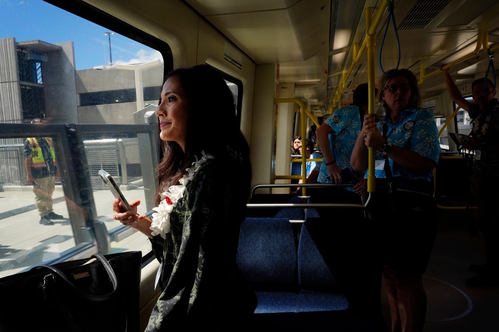 Council member Val Aquino Okimoto watches the Lelepaua Daniel K. Inouye International Airport station approach during the inaugural ride of the Skyline segment two Wednesday, Oct. 15, 2025, in Honolulu. The commuter train now extends past Hālawa Aloha Stadium to Kalihi’s Kahauiki Middle Street Transit Center. (Kevin Fujii/Civil Beat/2025)