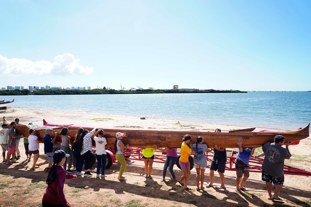 Prince Kūhiō’s A‘a moves into place to get rigged at Ke‘ehi Lagoon Friday, Nov. 7, 2025, in Honolulu. The ceremonial blessing and paddle ceremony will take place here the next day. (Kevin Fujii/Civil Beat/2025)