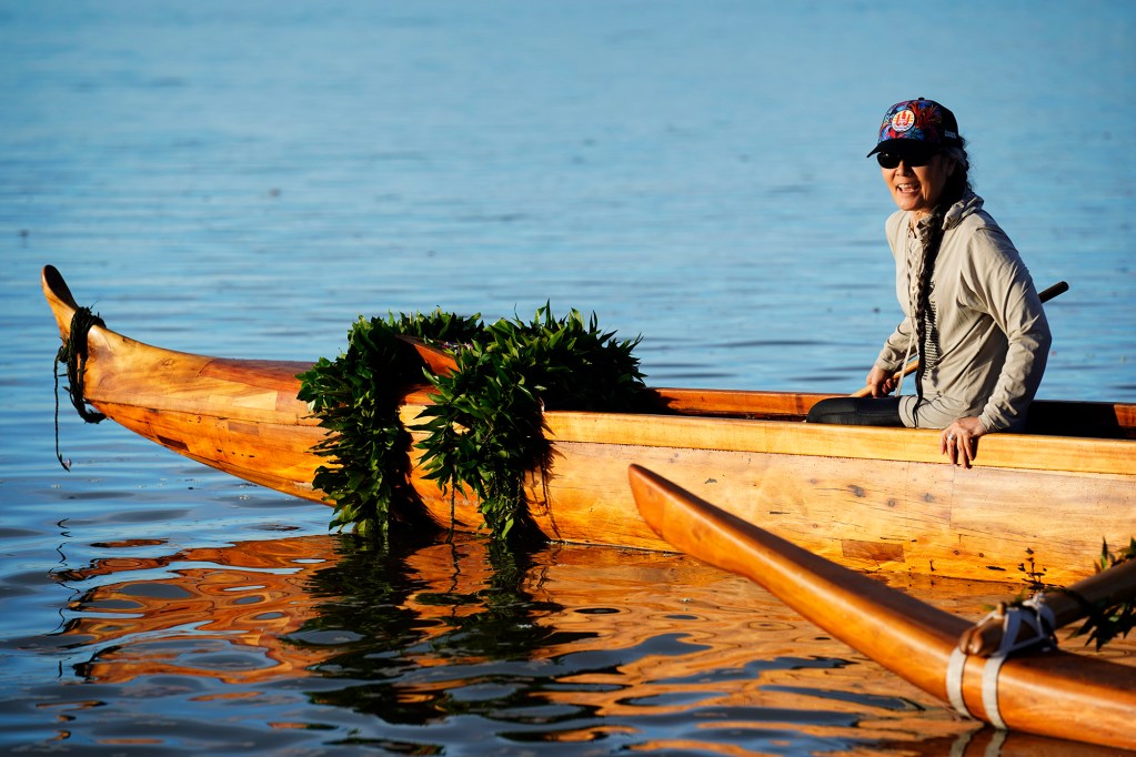 Michi Wong with the Friends of Hōkūleʻa and Hawaiʻiloa, prepares to paddle the A‘a for its second lap after the ceremonial blessing and inaugural paddle at Ke‘ehi Lagoon Saturday, Nov. 8, 2025, in Honolulu. The koa wa‘a was Prince Jonah Kūhiō Kalanianaʻole’s famous koa racing canoe. (Kevin Fujii/Civil Beat/2025)