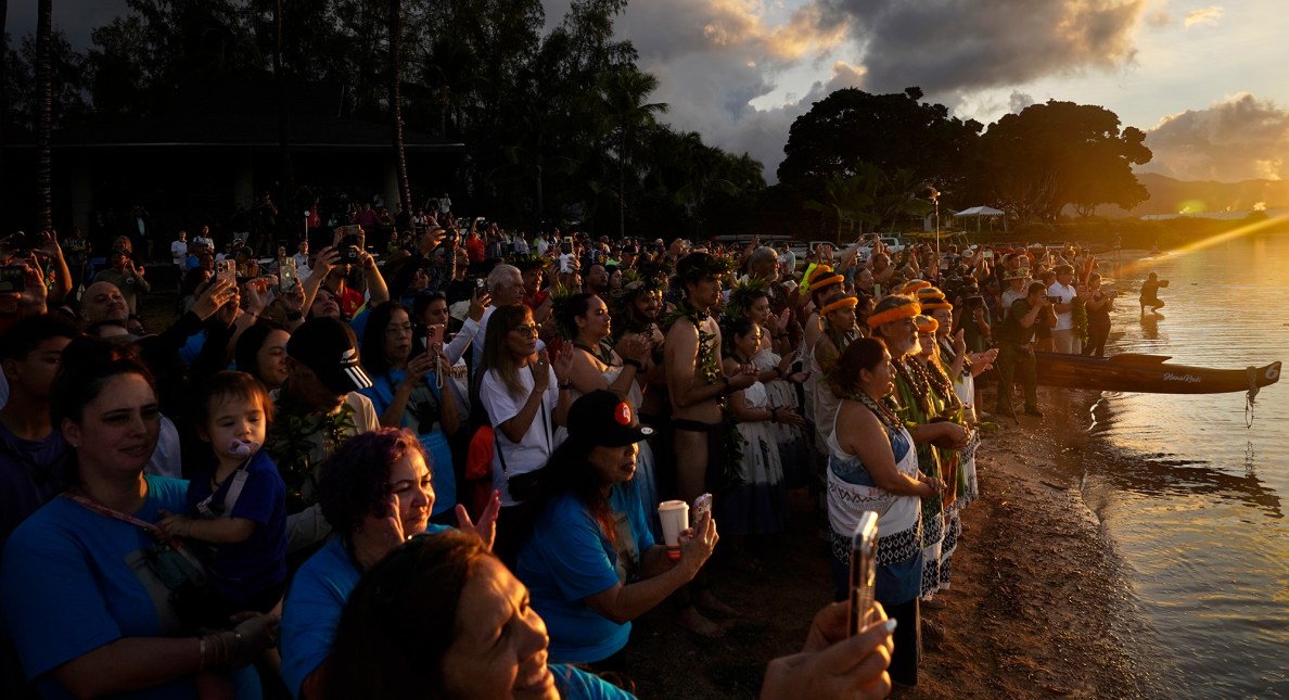 Cultural practitioners and the crowd watch Prince Jonah Kūhiō Kalanianaʻole’s famous koa racing canoe named the A‘a return to the ocean Saturday, Nov. 8, 2025, in Honolulu. (Kevin Fujii/Civil Beat/2025)