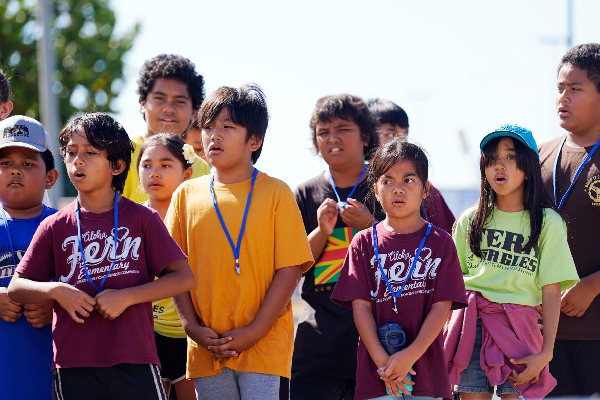 Fern Elementary School 4th graders sing a mele in ʻŌlelo Hawaiʻi to Polynesian Voyaging Society’s Nainoa Thompson during the Ho‘ākea Honolulu hands-on learning and experiencing event centered around traditional Hawaiʻian navigation and voyaging canoes Wednesday, Dec. 3, 2025, in Honolulu. Hawaiʻian voyaging traditions, cultural practices and ʻāina-based learning pairs with DOE curriculum to create a, “Navigator Mindset.” (Kevin Fujii/Civil Beat/2025)