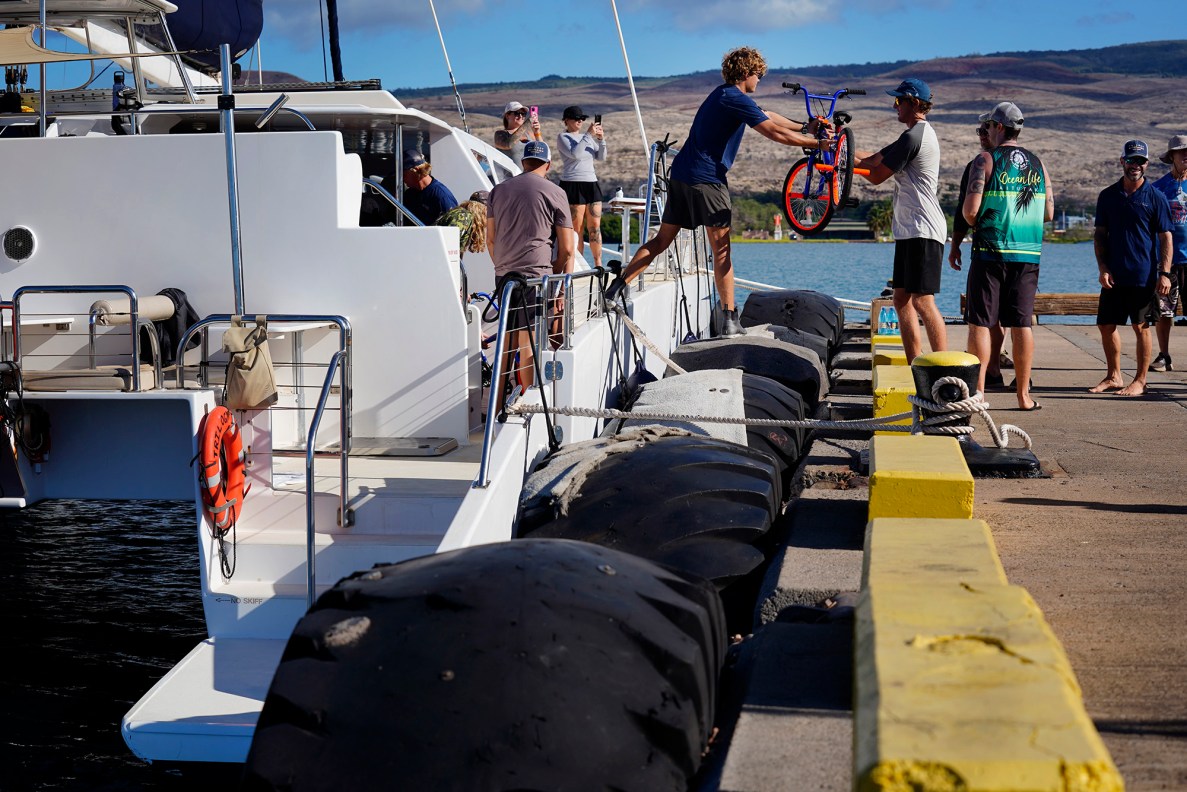 The Trilogy crew helps unload bikes for Jim Falk’s annual Christmas Kids Bike Build Wednesday, Dec. 10, 2025, at Molokaʻi Wharf in Kaunakakai. Approximately 450 new bicycles are built and will distributed to keiki in Maui County. (Kevin Fujii/Civil Beat/2025)
