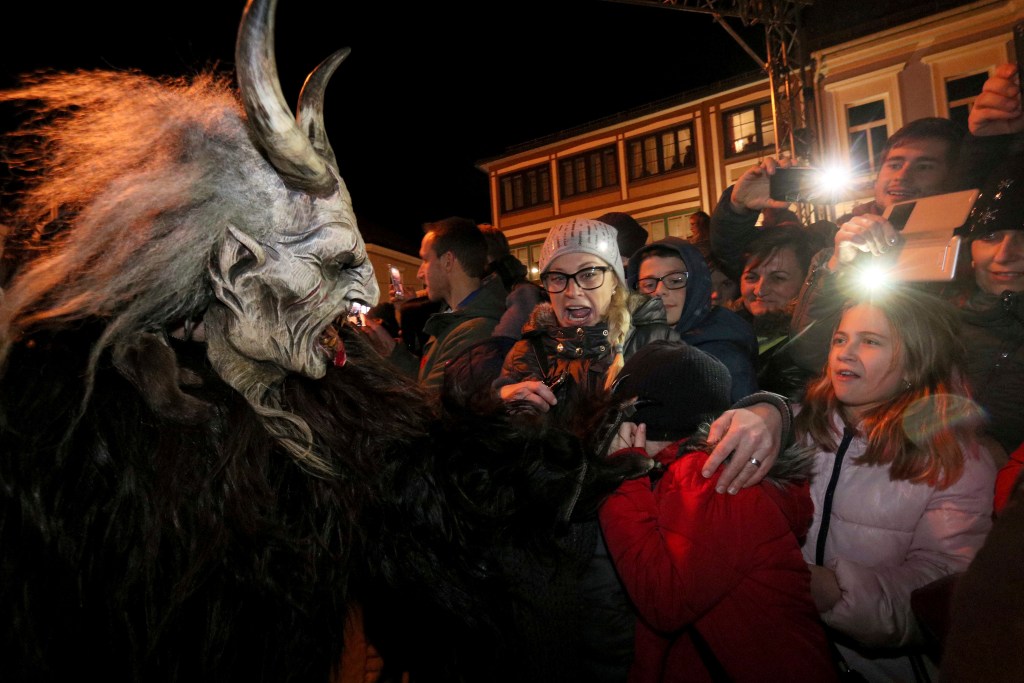 A man dressed as Krampus scares spectators during a Krampus run in Hollabrunn, Austria, Saturday, Nov. 25, 2017. (AP Photo/Ronald Zak)