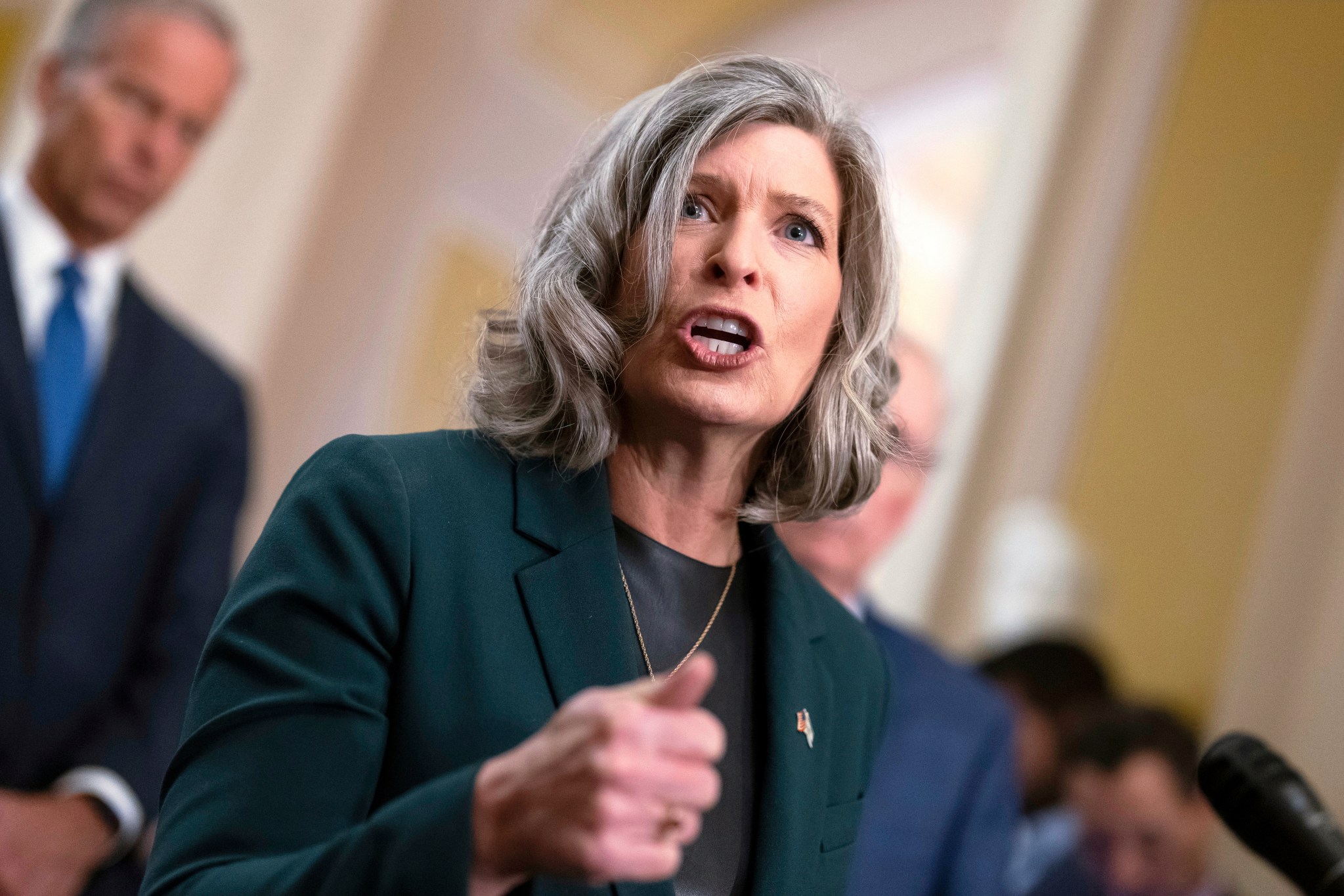 A woman gestures with her hand while speaking.