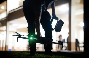 A drone pilot picks up his craft before Department of Law Enforcement Director Mike Lambert takes journalists on a ride along Wednesday, Dec. 31, 2025, in Waipahu. New laws, the use of aerial drones and citizens heeding the dangers of fireworks noticeably curbed the annual personal pyrotechnics. (Kevin Fujii/Civil Beat/2025)