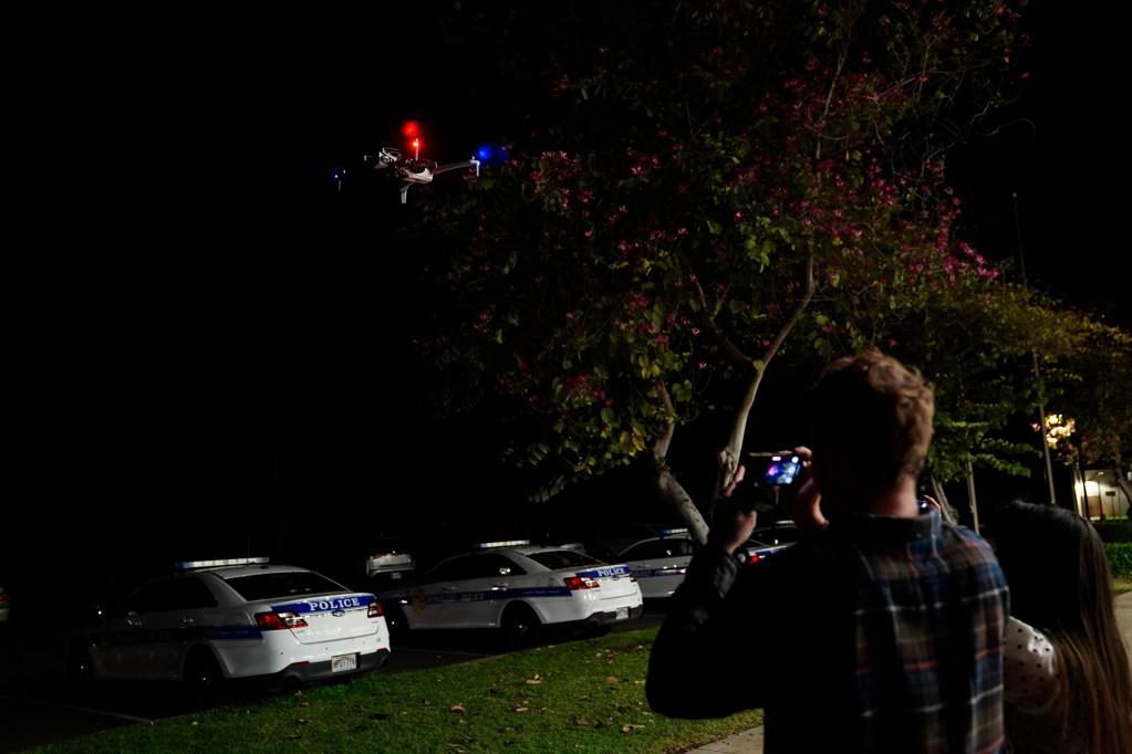 Journalists photograph a drone taking off before Department of Law Enforcement Director Mike Lambert takes them on a ride along Wednesday, Dec. 31, 2025, in Waipahu. New laws, the use of aerial drones and citizens heeding the dangers of fireworks noticeably  curbed the annual personal pyrotechnics. (Kevin Fujii/Civil Beat/2025)