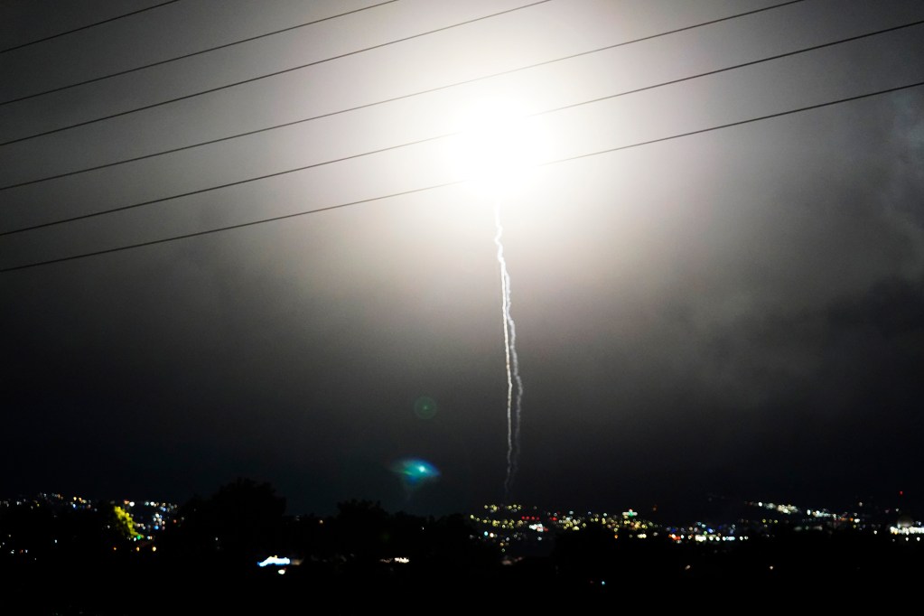 Illegal aerial pyrotechnics light up the New Year’s Eve sky Wednesday, Dec. 31, 2025, as seen from Waipahu. New laws, the use of aerial drones and citizens heeding the dangers of fireworks noticeably  curbed the annual personal pyrotechnics. (Kevin Fujii/Civil Beat/2025)