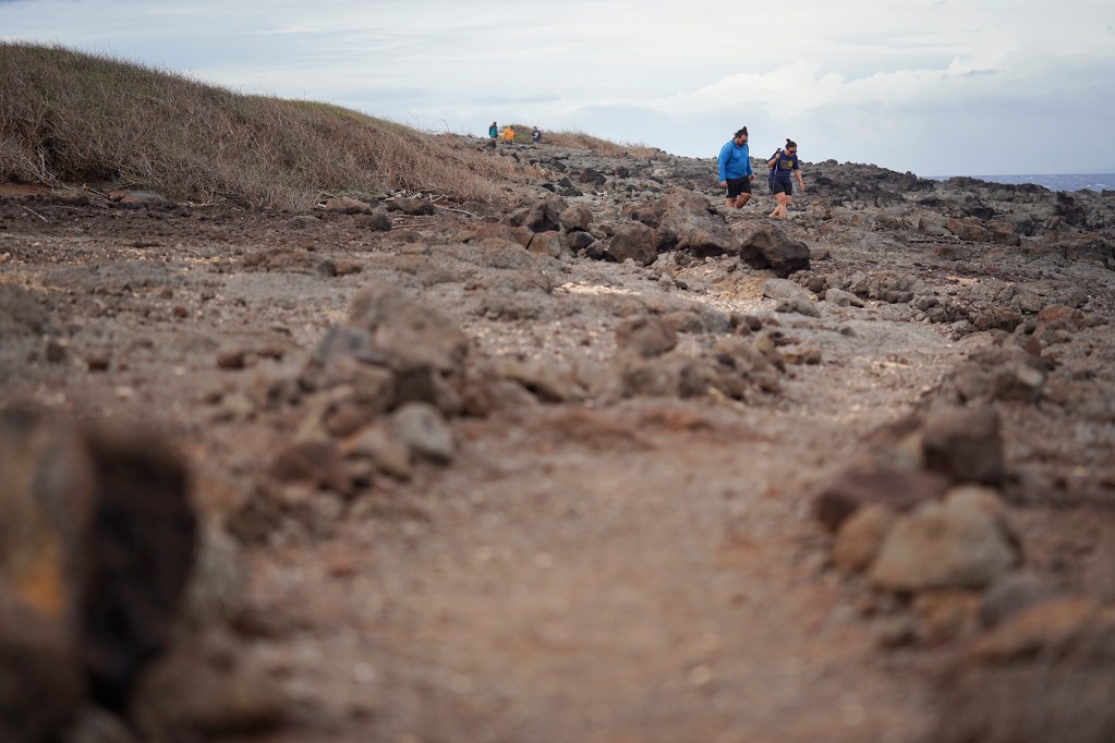 Kaipu Keala and Davianna Pomaika‘i McGregor walk on a Protect Kahoʻolawe ʻOhana (PKO) trail built and maintained in areas cleared of unexploded ordnance (UXO) Monday, Jan. 5, 2026, in Hakioawa. PKO celebrates the 50th year of sovereign land. (Kevin Fujii/Civil Beat/2026)