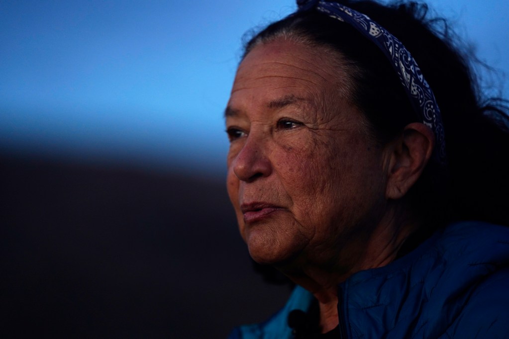 The sun begins to illuminate Protect Kahoʻolawe ʻOhana (PKO) Davianna Pomaika‘i McGregor before performing the sunrise protocol Monday, Jan. 5, 2026, in Hakioawa. PKO celebrates the 50th year of sovereign land. (Kevin Fujii/Civil Beat/2026)