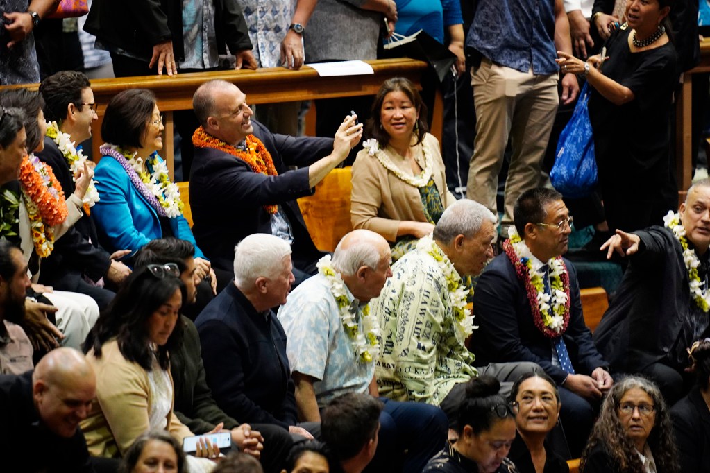 Gov. Josh Green makes a selfie with U.S. Sens. Mazie Hirono, Brian Schatz and Lt. Gov. Sylvia Luke before the Hawaiʻi State Legislature opens Wednesday, Jan. 21, 2026, in Honolulu. (Kevin Fujii/Civil Beat/2026)