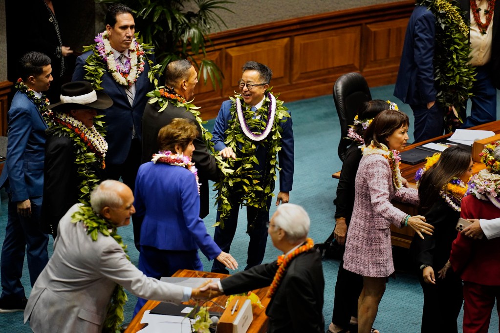 Sen. Glenn Wakai, center, greets Sen. Kurt Fevella before the Hawaiʻi State Legislature opens Wednesday, Jan. 21, 2026, in Honolulu. (Kevin Fujii/Civil Beat/2026)
