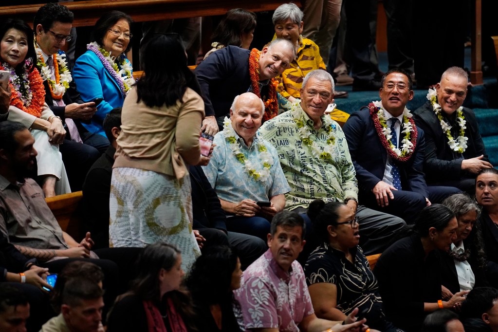 Maui Director of Communications and Government Affairs Laksmi Abraham gets smiles for a photo from Honolulu Mayor Rick Blangiardi, from lower left, Maui Mayor Richard Bissen, Kauaʻi Mayor Derek Kawakami, Hawaiʻi Mayor Kimo Alameda, Lt. Gov. Sylvia Luke, from upper left, U.S. Sens. Brian Schatz and Mazie Hirono and Gov. Josh Green The Hawaiʻi State Legislature opens Wednesday, Jan. 21, 2026, in Honolulu. (Kevin Fujii/Civil Beat/2026)