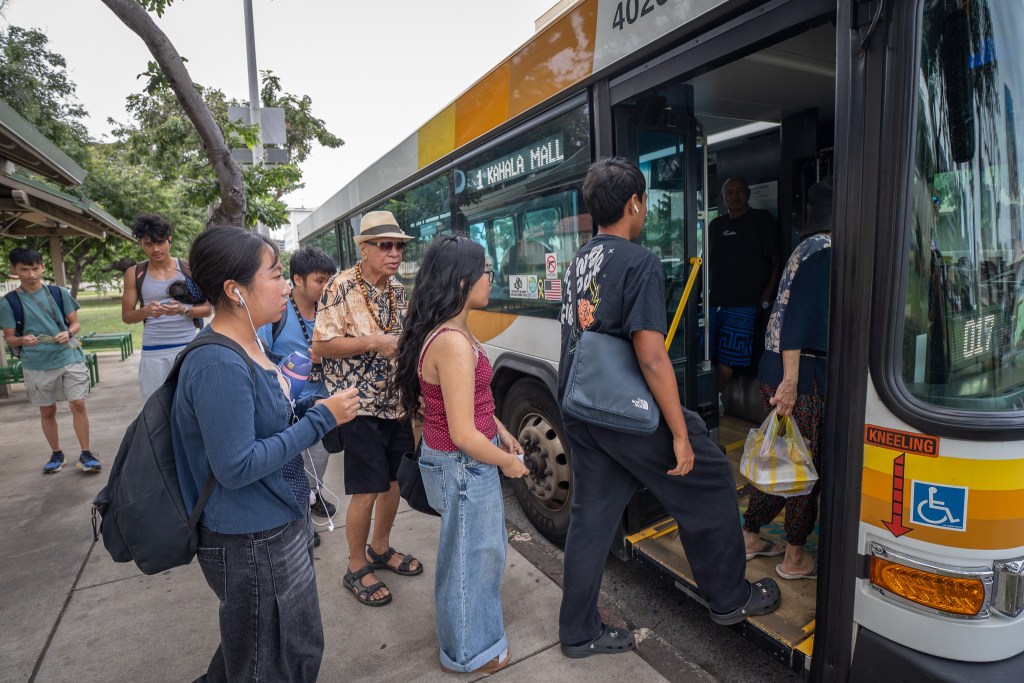 Several McKinley High School students board a Kahala-bound bus at Pensacola and King Sts in Honolulu, Thursday, Feb. 19, 2026. (Craig Fujii for Civil Beat)