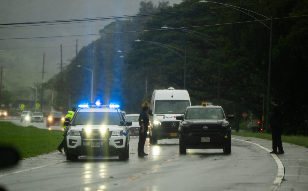Honolulu Police closed a section of Kahekili Hwy at 'Ahuimanu March 13, 2026. A slow-moving Kona storm continues pour rain on Hawaii and is expected to continue this weekend.