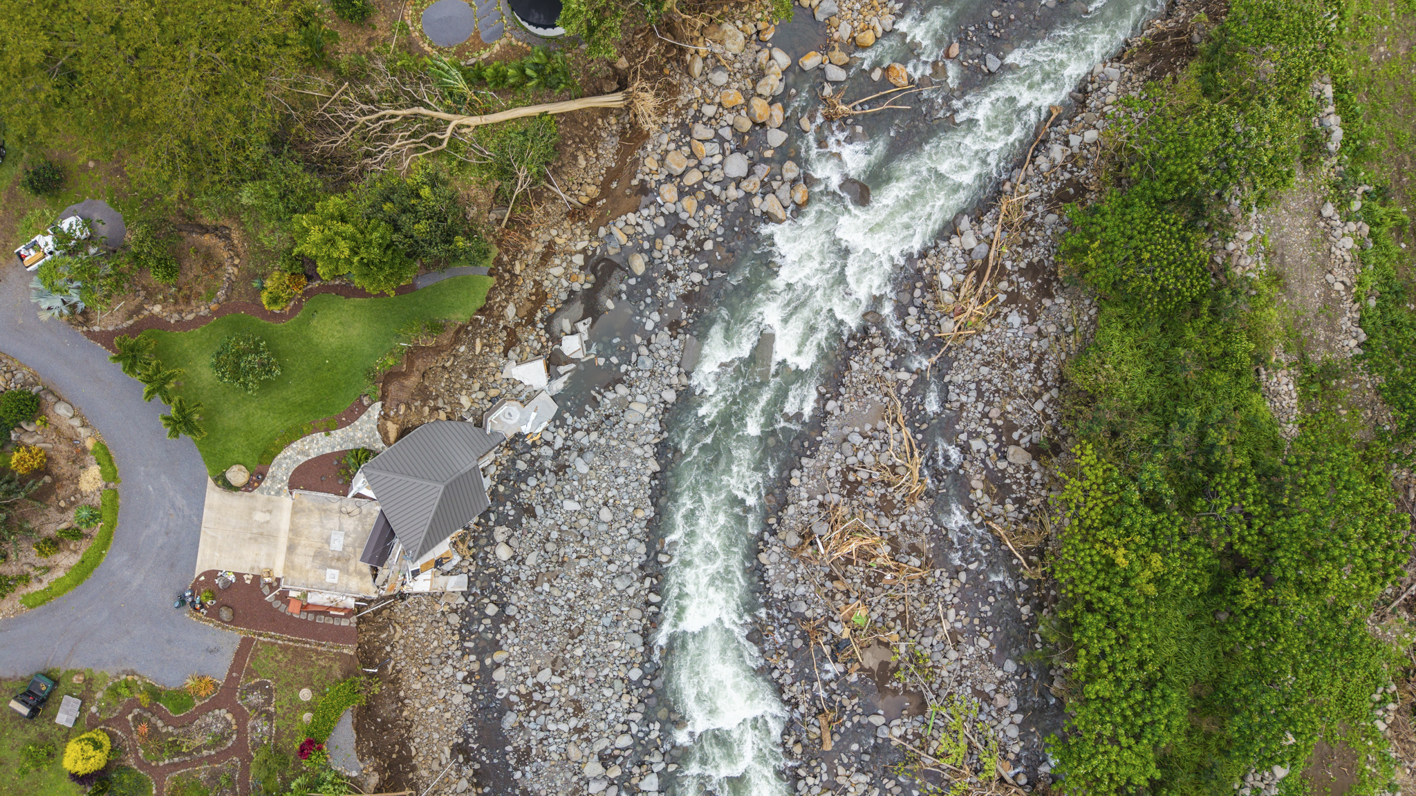 A home collapsed into a stream on Maui during the flooding from a Kona low storm the weekend of March 14, 2026. (Sean Hower/Civil Beat/2026)