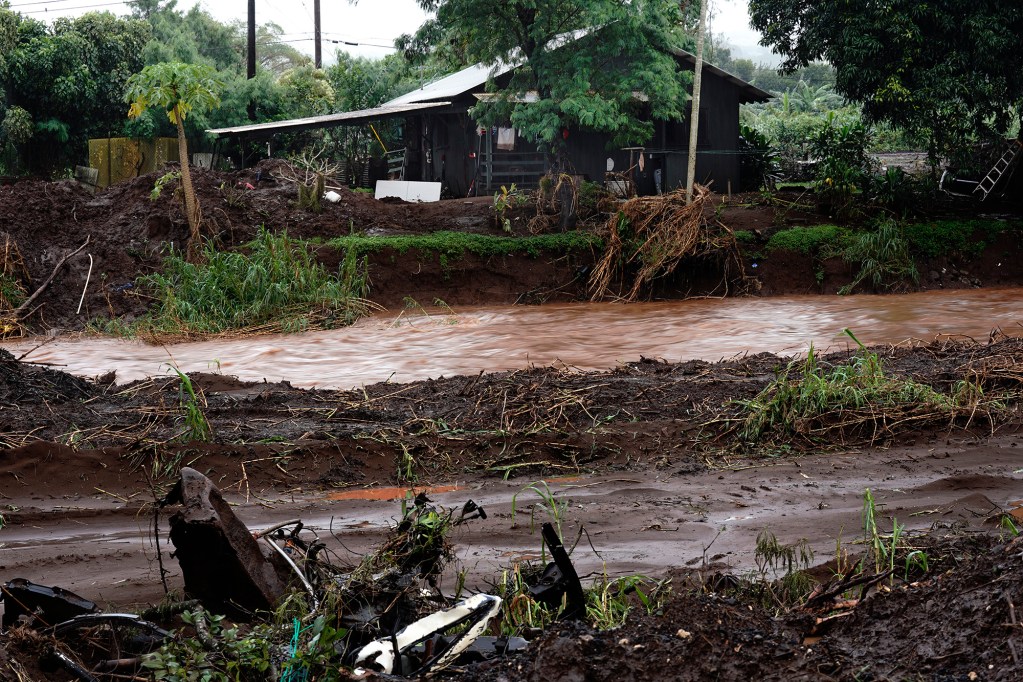 The Kaukonahua Stream remains in its banks and under Otake Bridge despite the mandatory evacuation of Otake Camp in Waialua Friday, April 10, 2026. The North Shore community is on edge after flooding from a recent Kona Low storm. (Kevin Fujii/Civil Beat/2026)