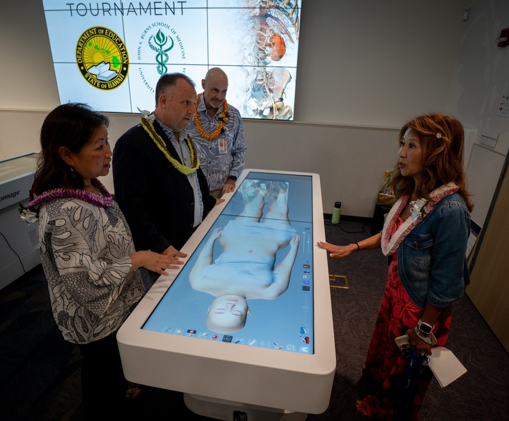 First Lady Jaime Green and Gov. Josh Green speak with Dr. Jaimie Tom at an educational event featuring a virtual cadaver table created by Anatomage of Santa Clara, Calif., at JABSOM April 7, 2026. Medical school dean Sam Shomaker looks on. (Craig Fujii/Civil Beat/2026)