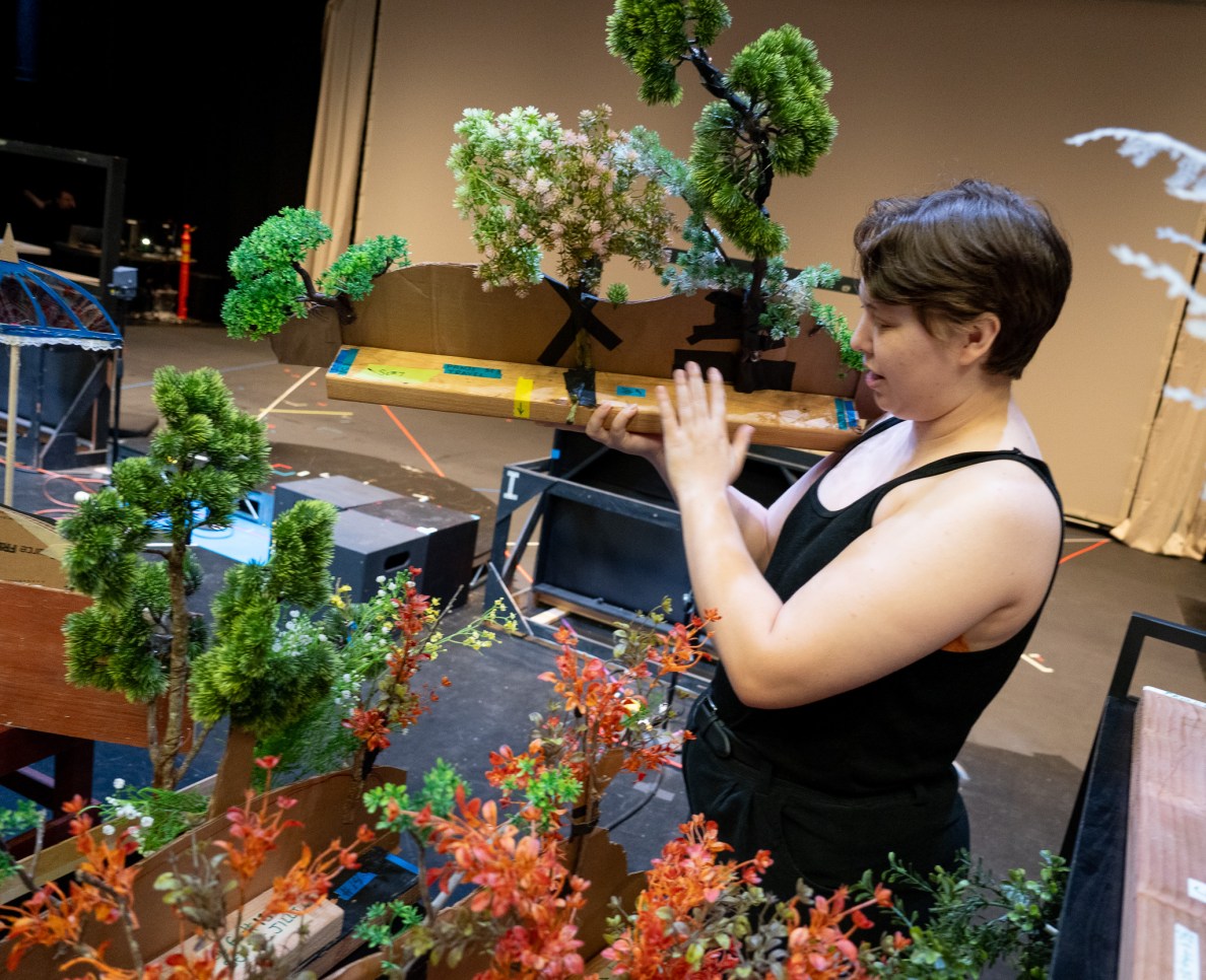 Graduate student Arlo Rowe holds shrub props that are used as shadow landscaping pieces at the Kennedy Theatre's production of Panji and the Lost Princess April 16, 2026. (Craig Fujii/Civil Beat/2026)