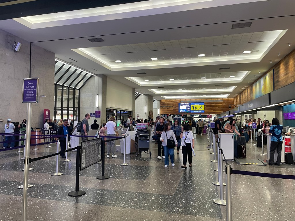 People in an airport departure lounge.