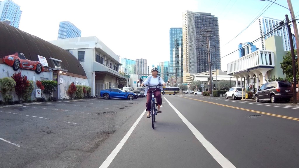 Hawai‘i Bicycling League Board of Directors president Samantha Lara rides her e-bike on Queen Street Wednesday, May 13, 2026, in Honolulu. (Kevin Fujii/Civil Beat/2026)