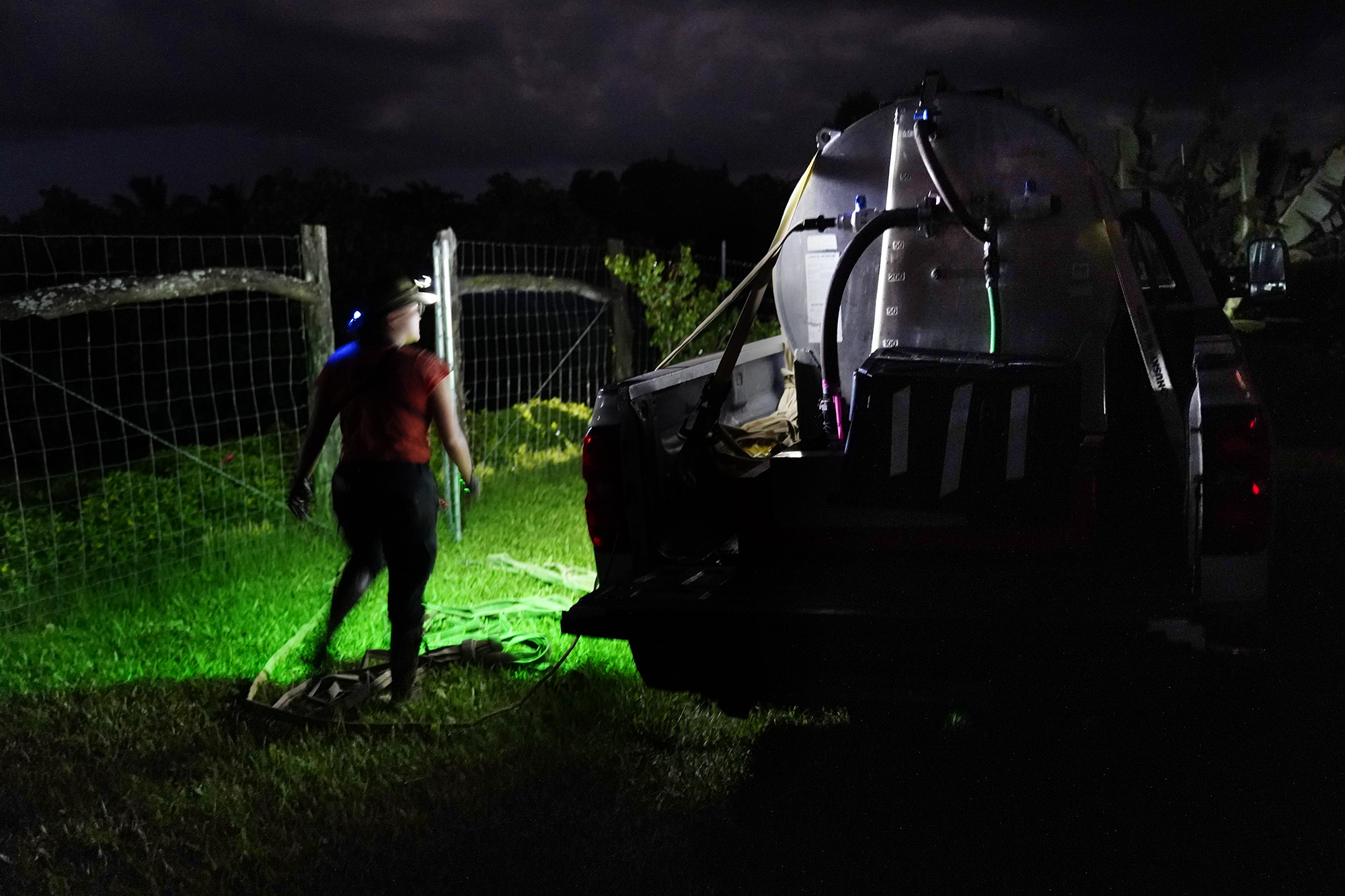 Maui Invasive Species Committee field associated Kaelyn Leval prepares to spray a citric-acid solution on invasive coqui frogs Tuesday, May 26, 2026, in a Haʻikū gulch. (Kevin Fujii/Civil Beat/2024)