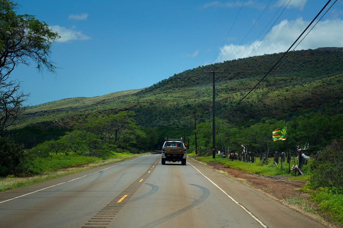 A County of Maui work truck drives toward Kaunakakai on Hawaiʻi State Route 450 in this stock/file photo of rural Molokaʻi Wednesday, May 27, 2026. (Kevin Fujii/Civil Beat/2026)