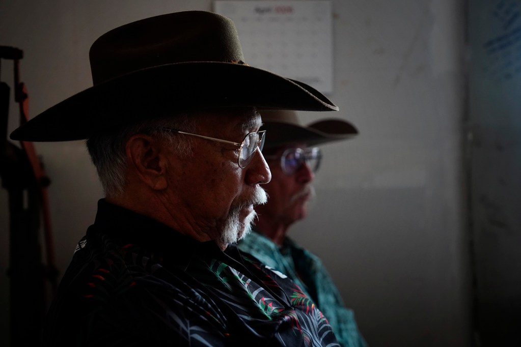Uncle Jimmy Duvauchelle, left, and Uncle Phillip “Mango” Stephens along with other Molokaʻi cattle ranchers talk with Honolulu Civil Beat Wednesday, May 27, 2026, in Kaunakakai. They are dealing with the state’s imposed bovine tuberculosis quarantine. (Kevin Fujii/Civil Beat/2026)