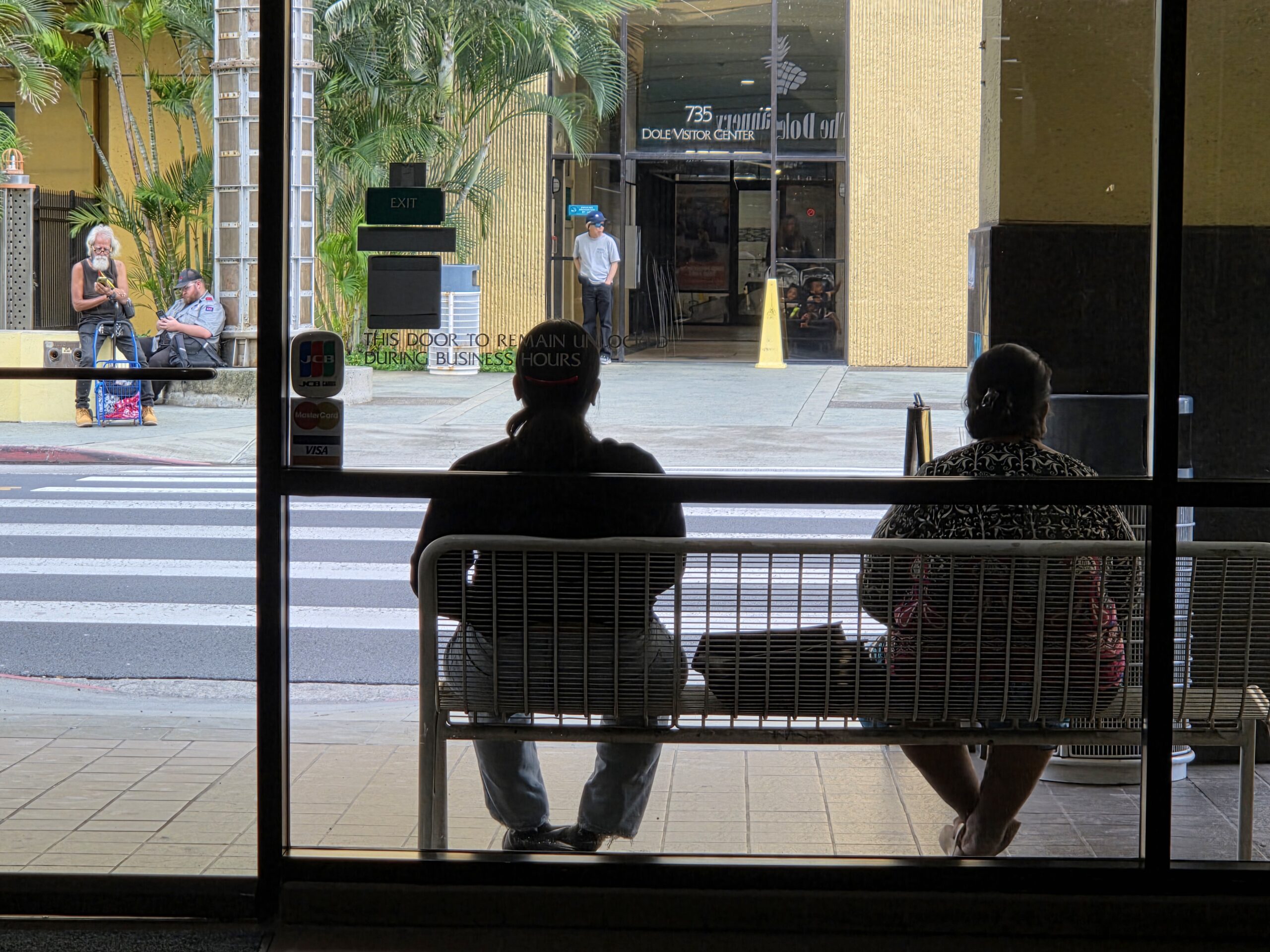 Anderina and Marianeina, after their meeting about housing options, wait for their third Handivan of the day to take them back to Waiʻanae.