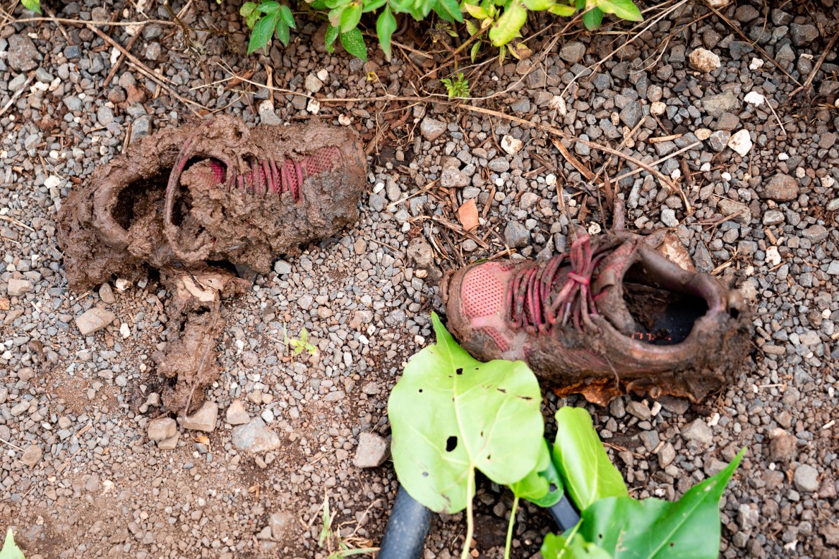 Shoes that lost a a battle against mud at Mill 6 Farms in Waialua May 23, 2026. The Waialua Farmers Cooperative and volunteers started the daunting task of clearing ditches of overgrown trees which slowed the drainage of rainwater causing flooding during the March Kona low storms. (Craig Fujii/Civil Beat/2026)