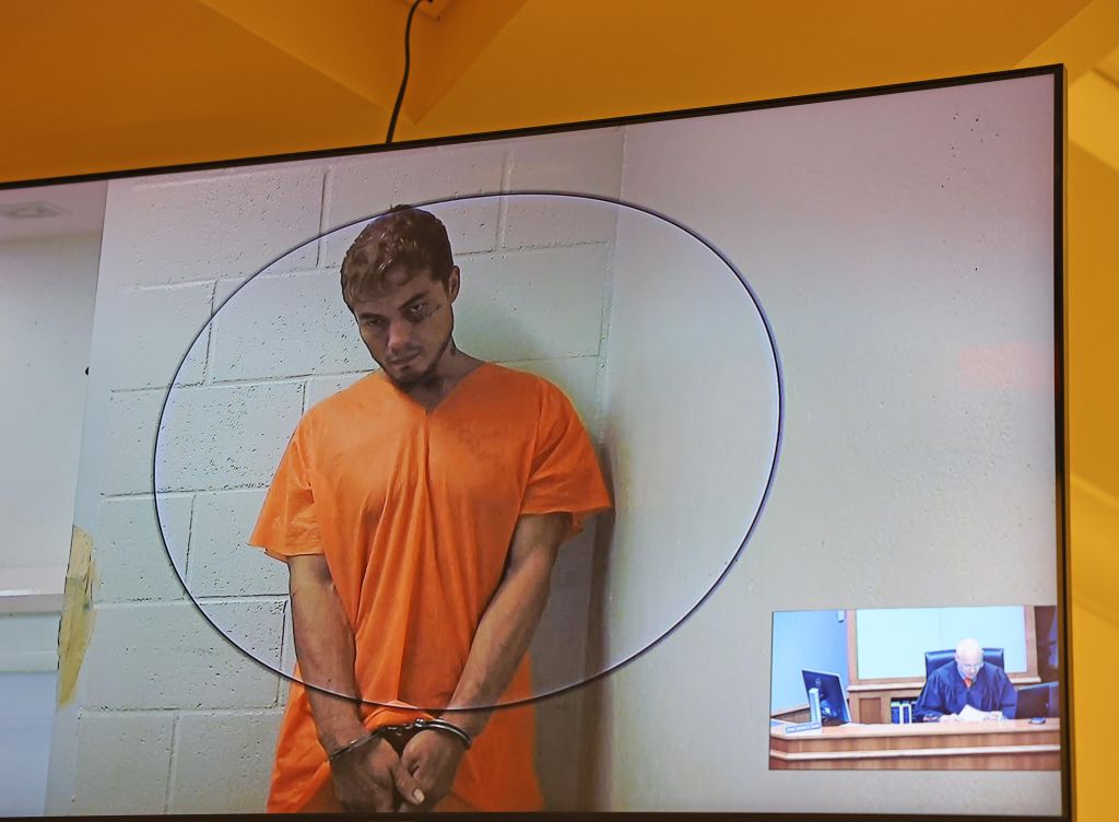 Jacob Baker appears on a screen before the Hilo court wearing an orange jump suit.