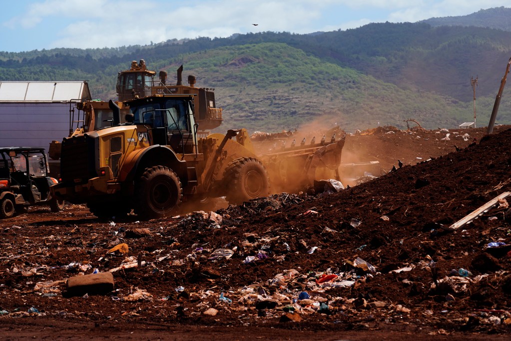 County of Kauaʻi workers spread rubbish before covering it with dirt at Kekaha Landfill Friday, June 5, 2026, in Kekaha. (Kevin Fujii/Civil Beat/2026)